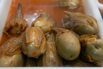 Pickled and marinated mini eggplants vegetables on farmers market, variety of tasty tapas in Andalusia, Spain