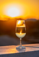 Drinking of cava or champagne sparkling wine on outdoor roof terrace with view on central part of old Sevilla, Andalusia, Spain sunset