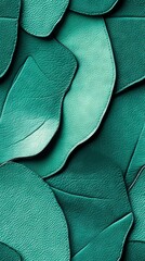   A close-up shot of emerald-colored leather featuring a leafy texture on both sides