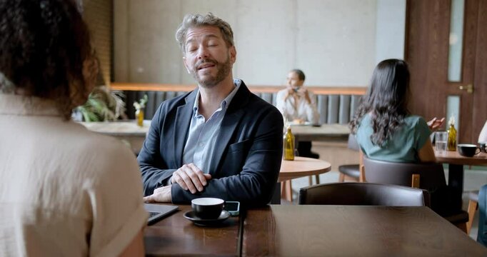 Mature Male Manager having Job interview in Cafe Restaurant