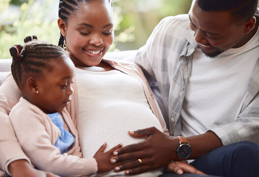 Black family, happy and stomach touch for pregnancy, bonding and support in living room with belly growth. Mother, people and pregnant in house for abdomen feel, maternity and motherhood with embrace