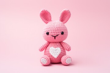 Pink Crochet Amigurumi Bunny on Pink Background
