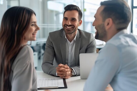 A couple seated at a table with a laptop, working together - Powered by Adobe