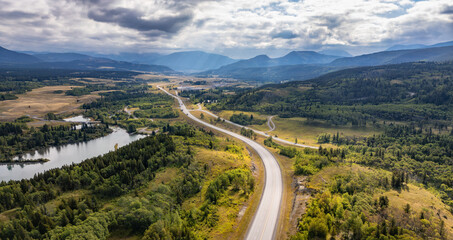 Scenic Highway Winding Through Majestic Landscape in Alberta, Canada with Lush Forests and Mountains