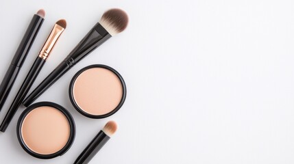 Makeup brushes and powders on a white isolate background.