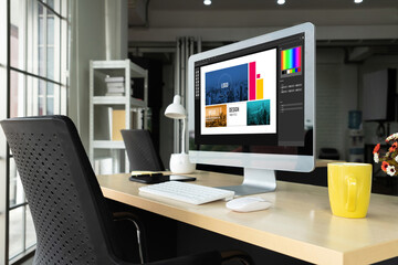 Graphic designer software for modern design of web page and commercial ads showing on the computer screen