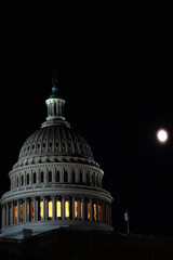 us capitol building at night with moon in background 