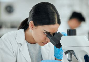 Woman, microscope and science in lab for healthcare, investigation or experiment results. Scientist, tech or study at table for medicine engineering, pharmaceutical development or research innovation