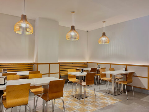 Background image of empty food court interior with wooden tables and warm cozy light setting