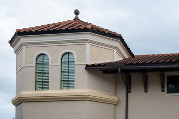 The top floor of a modern residence with an octagon dome style room with two arched windows. The...