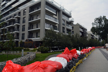 Bags of walking next to the house. Flood protection. Threat of flooding by the river. Wroclaw, Poland September 2024