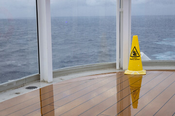 Wet floor sign on deck of cruise ship