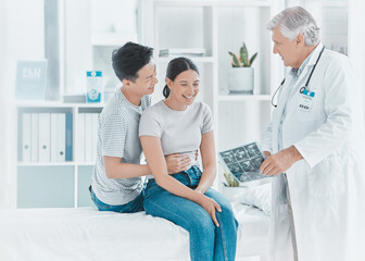 Fototapeta premium Couple, doctor and pregnancy scan at clinic, ultrasound diagnosis and excited for ivf success. Mature man, gynecologist and plan with people for maternity progress, exam and discuss utero healthcare