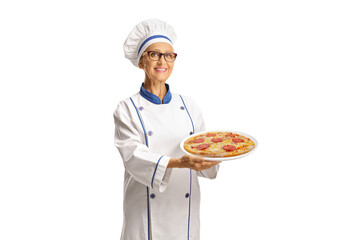 Female chef holding pizza on a plate
