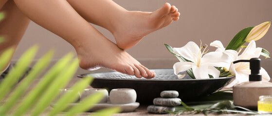 Woman undergoing spa pedicure treatment in salon, closeup