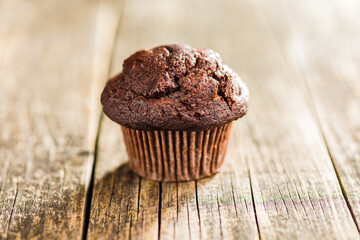 Sweet chocolate muffin cakes. Cupcakes on wooden table.