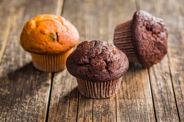 Sweet chocolate muffin cakes. Cupcakes on wooden table.