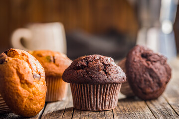 Sweet chocolate muffin cakes. Cupcakes on wooden table.