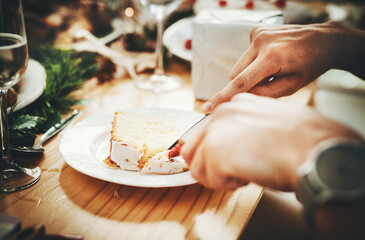 Hands, person and eating cake in home for dessert, christmas celebration and social gathering at dining table. Holiday, people and snack at dinner party for sweet treat, lunch and delicious food