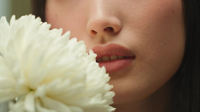 Close up unrecognizable Asian woman female girl chinese korean lady face smell flower natural organic cosmetics fresh fragrance blossom perfume skincare moisturizer cosmetology makeup beauty medical