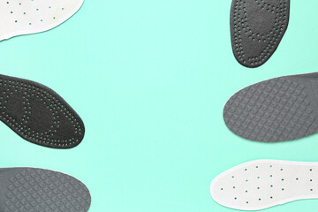 Composition with different orthopedic insoles on color background