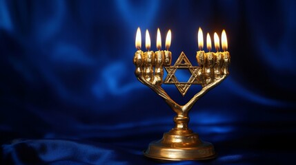 Fototapeta premium Golden Menorah with Burning Candles and Star of David on Blue Satin