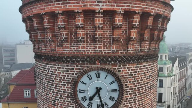 Drone footage of Spremberger Tower with the classic buildings of Cottbus in the fog, in Germany