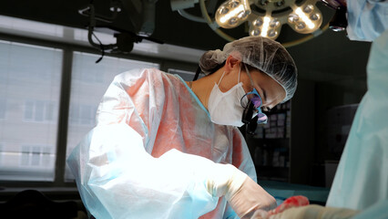 Team of skilled surgeons and assistants conduct complex operation modern medicine. Doctors and...