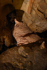 An old ladder lying at the bottom of a cave.
