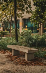 A photo of a concrete bench in a park. The bench is situated near a tree, with lush green leaves. There's a path leading to the bench. The background contains other benches and trees. 