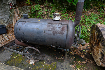 An old rusty boiler converted into a spit.
