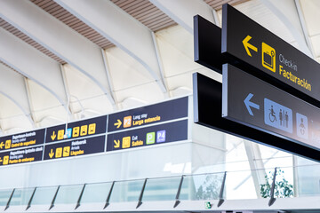 Airport signage close-up directing passengers at terminal