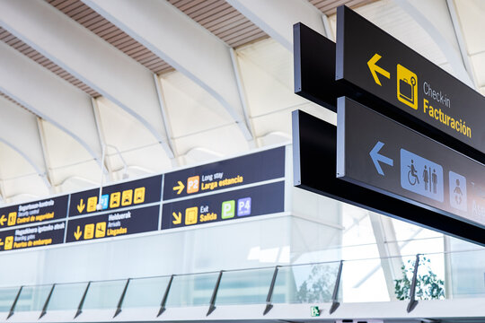 Airport signage close-up directing passengers at terminal