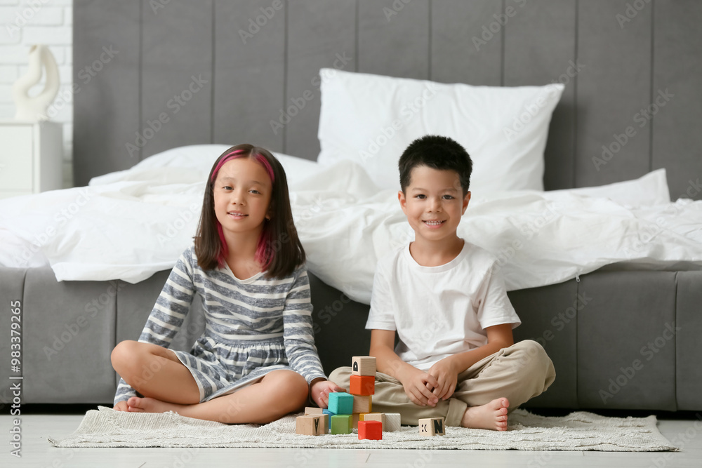 Canvas Prints Cute happy Asian children playing with cubes in bedroom at home