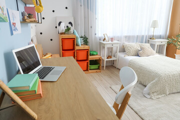 Interior of children's room with bed, study table and shelves