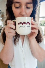 Gorgeous mug with hearts held by young lady