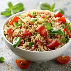 Quinoa salad with cherry tomatoes, fresh herbs in a white bowl. Healthy food concept.