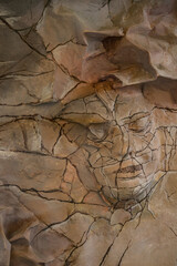 A face peeking out of the paper.
