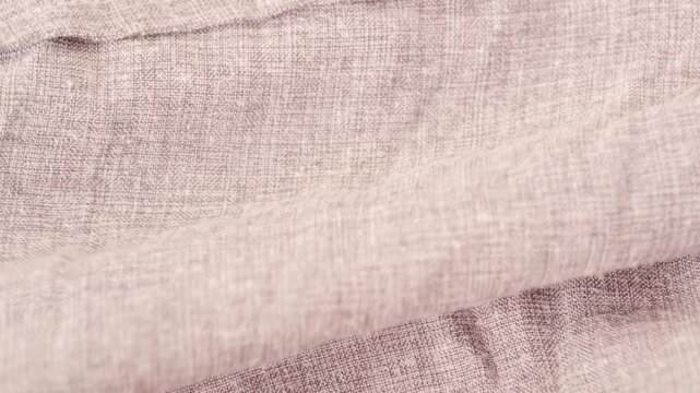 Female hands inspecting texture and quality cotton, linen fabric, testing for durability, stretch and crease resistance