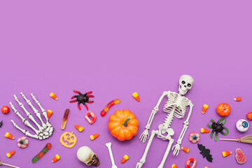 Composition with sweets and decorations for Halloween on purple background