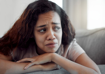 Fototapeta premium Woman, depression and crying for sad, mental health and trauma in house with insomnia, grief and loss. Female person, anxiety and fatigue for burnout, pain and broken heart in apartment with sorrow