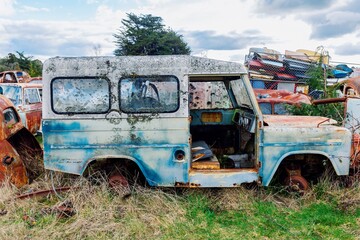 Abandoned and rusted classic cars  in the The historical Horopito Motor Wreckers - Smash Palace,...