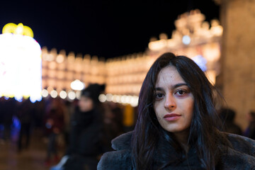 mujer morena joven posando en invierno cazadora de abrigo negra larga moda 2023