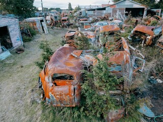 Abandoned and rusted classic cars  in the The historical Horopito Motor Wreckers - Smash Palace,...