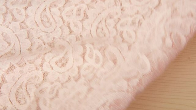 female Hand touching lace material, Seamstress inspects relief fabric surface, lace dress, assessing quality and tactile properties for sewing