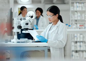 Scientist, study and woman with tablet by microscope for medical research, pathogen and...