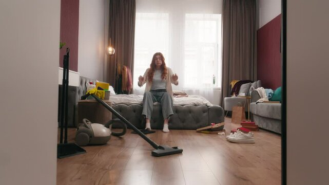 Exhausted sad upset Caucasian woman girl female homeowner lady housewife tired headache stress anxious frustrated mess in bedroom cleaning home chore problem trouble messy dirty housekeeping cleanup