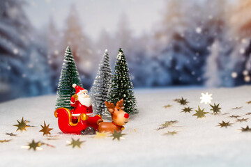 A small red sleigh with a Santa Claus is pulling a reindeer, Christmas and New Year's Eve.