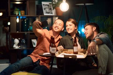 Group, selfie and night as friends, colleagues or employees in digital agency for web design. People, happiness and working late for collaboration, support or networking as creative for social media