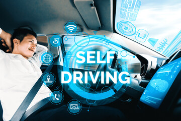 Self-driving autonomous car with relaxed young man sitting at driver seat is driving on busy highway road in the city. Concept of machine learning, artificial intelligence and augmented reality. uds